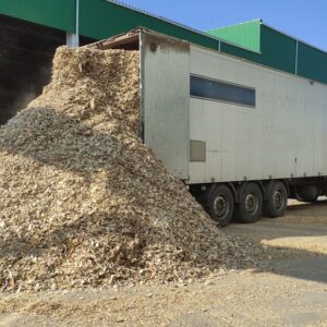 Truck,Unloads,Wood,Chips,Into,A,Warehouse.